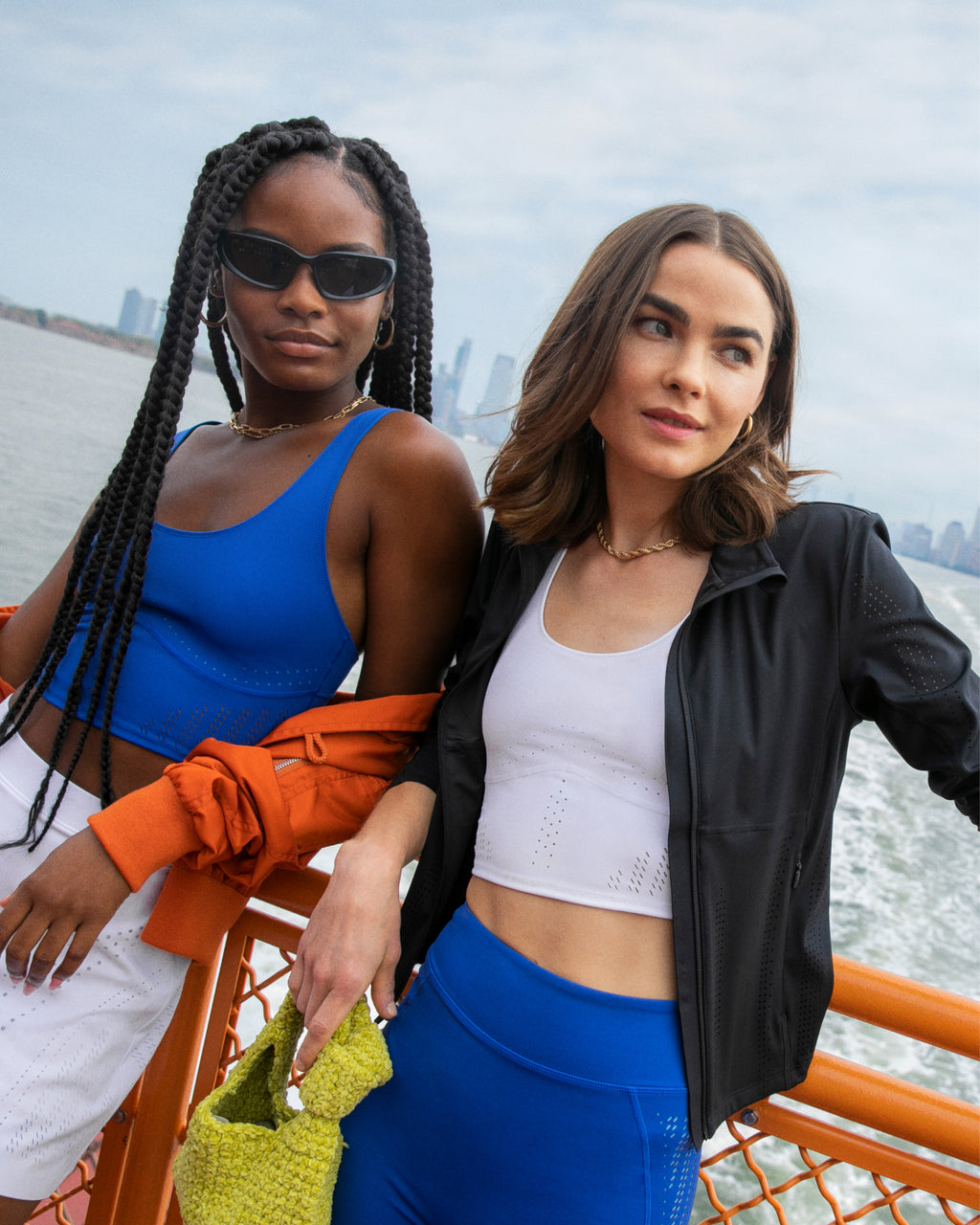 Models wearing the Lasercut collection from BANDIER on the ferry with the New York skyline behind them